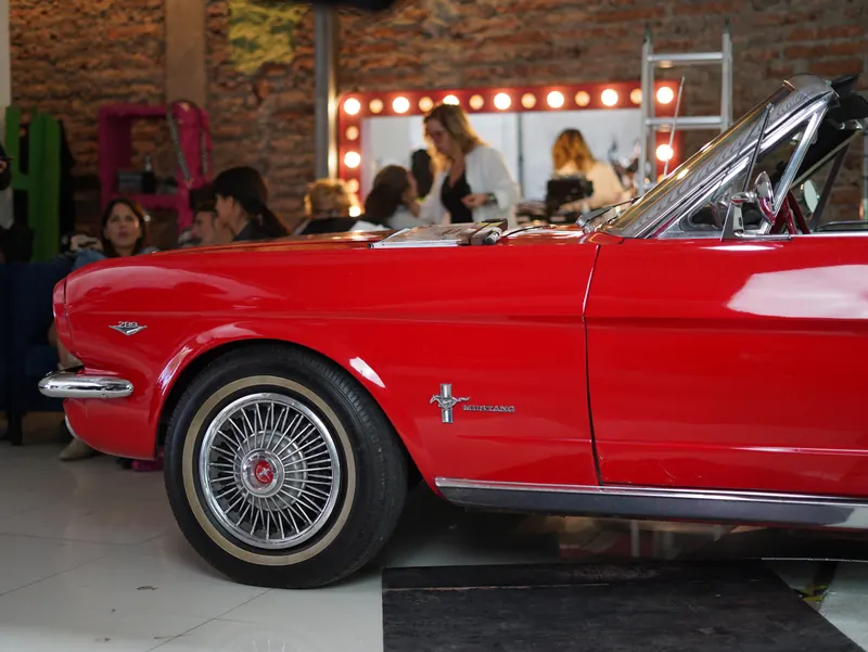 A red 1960s Mustang convertible on set