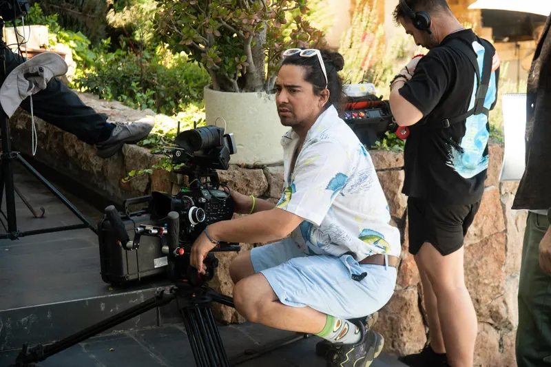 A camera operator shoots outdoors during production